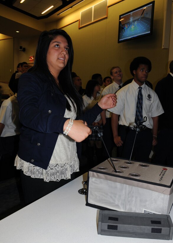 Rebecca Gonzalez, a student from O’Conner High School, attempts to perform a task on an endoscopic simulator at the Association of Naval Service Officers “Youth Day,” which was held at the Medical Education and Training Campus aboard Fort Sam Houston, May 4, 2011, in San Antonio.